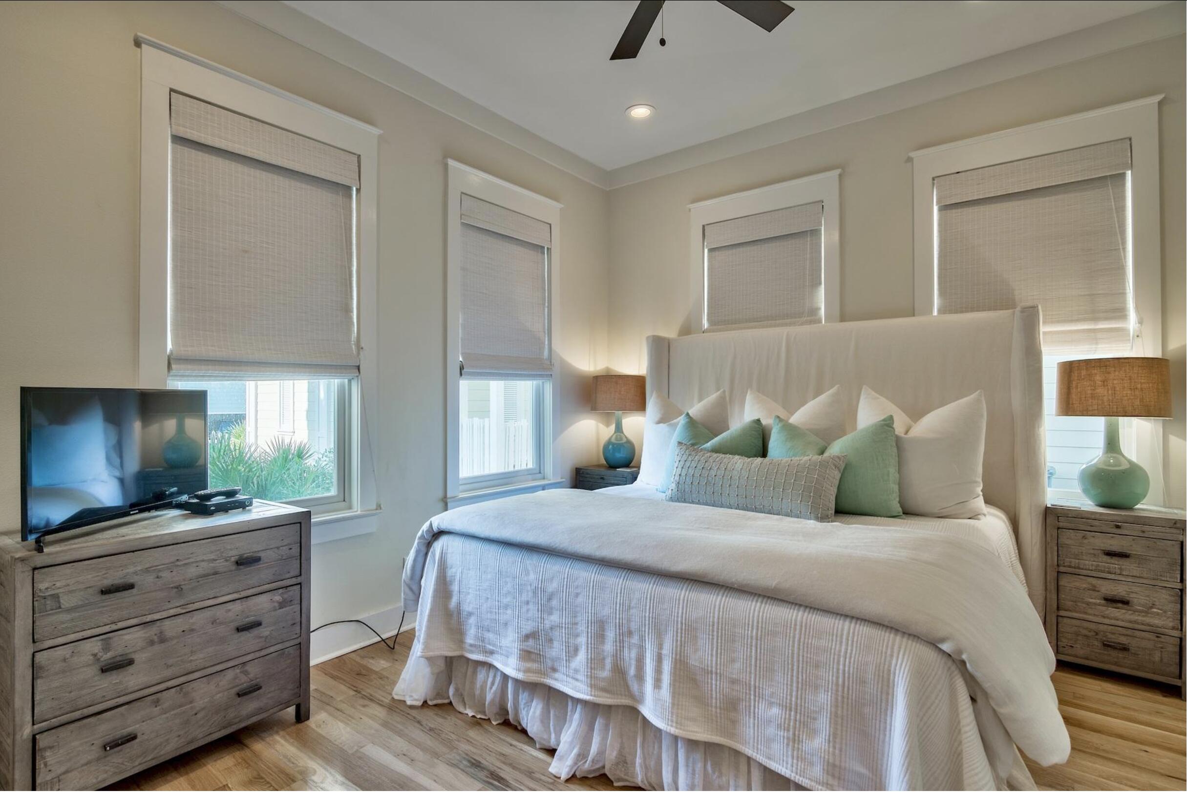 64 Chelsea Loop Road Santa Rosa Beach, FL 32459 - Photo 12 of 57 a bedroom with a large bed and flat tv screen on dresser