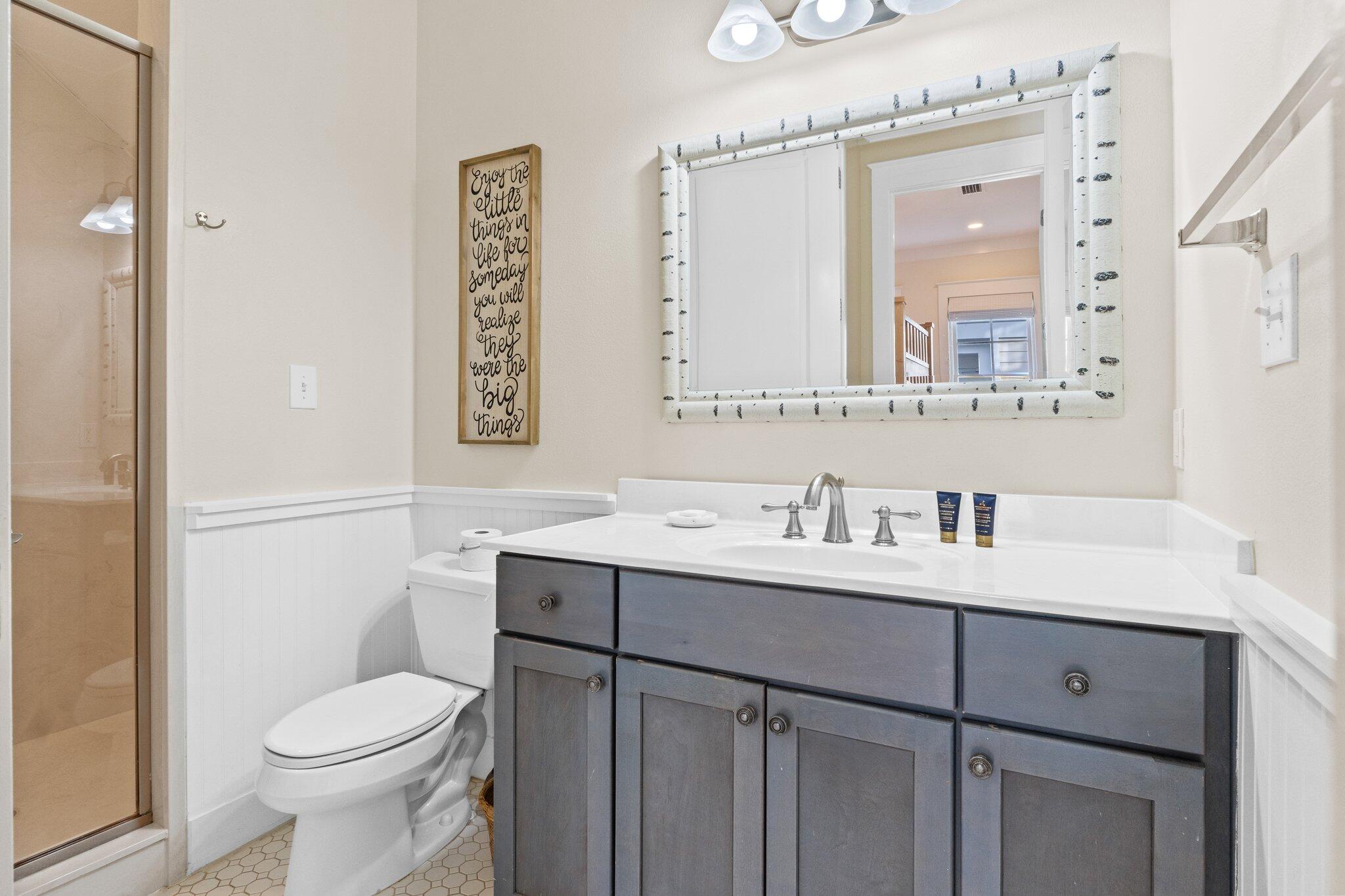 64 Chelsea Loop Road Santa Rosa Beach, FL 32459 - Photo 15 of 57 a bathroom with a toilet sink vanity and mirror