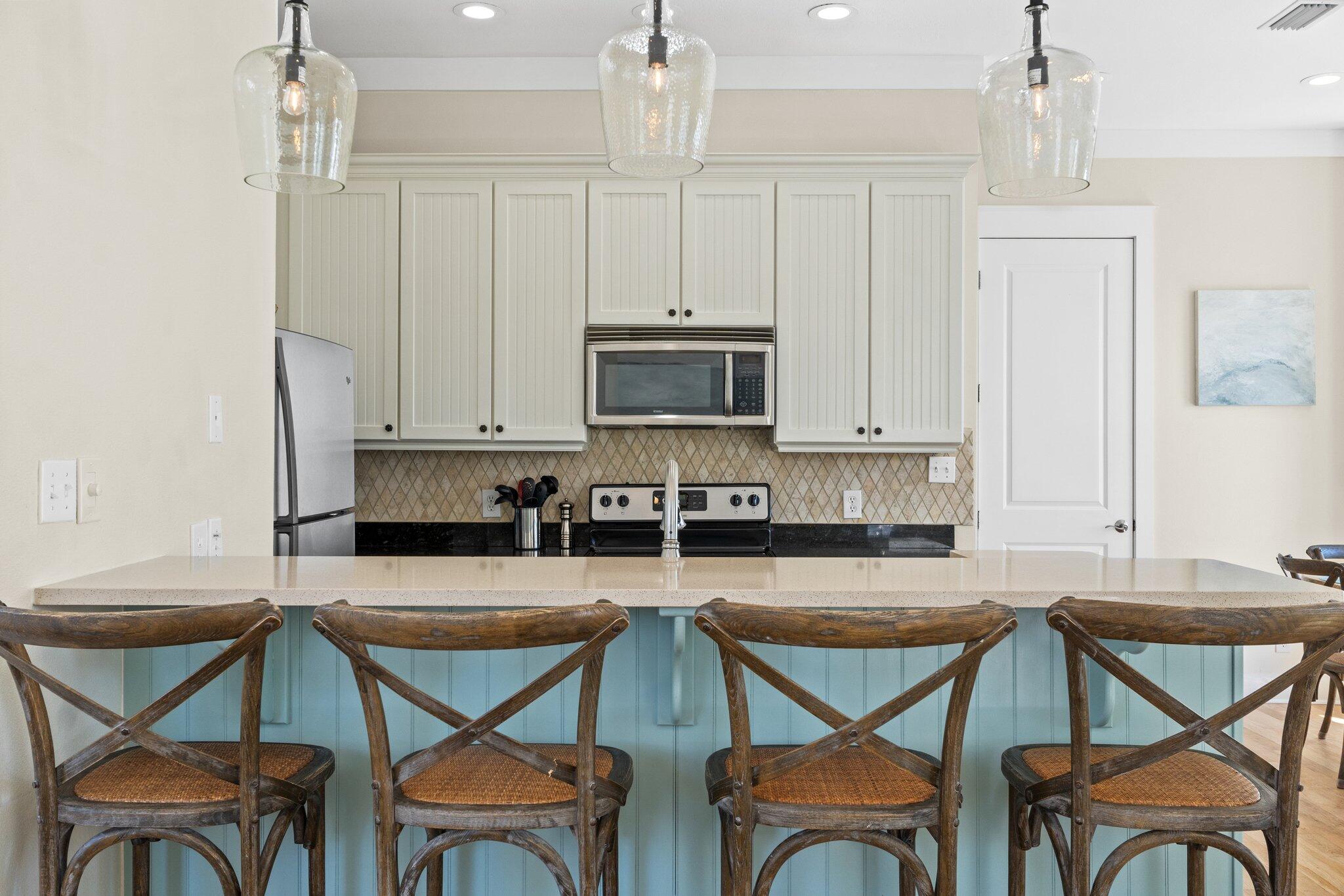 64 Chelsea Loop Road Santa Rosa Beach, FL 32459 - Photo 9 of 57 a kitchen with a table chairs stove and cabinets