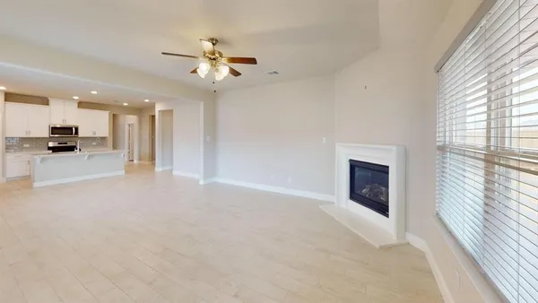 a view of a kitchen with a sink and a fireplace