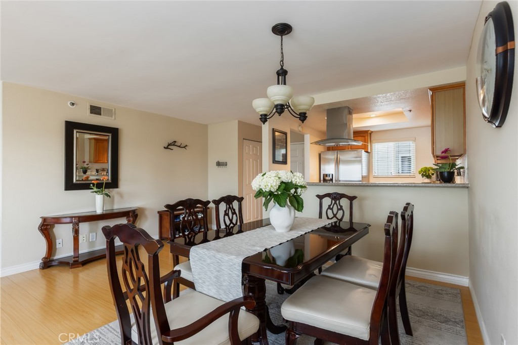 726 Elm Avenue, Unit 404 Long Beach, CA 90813 - Photo 9 of 31 a view of a dining room with furniture and wooden floor