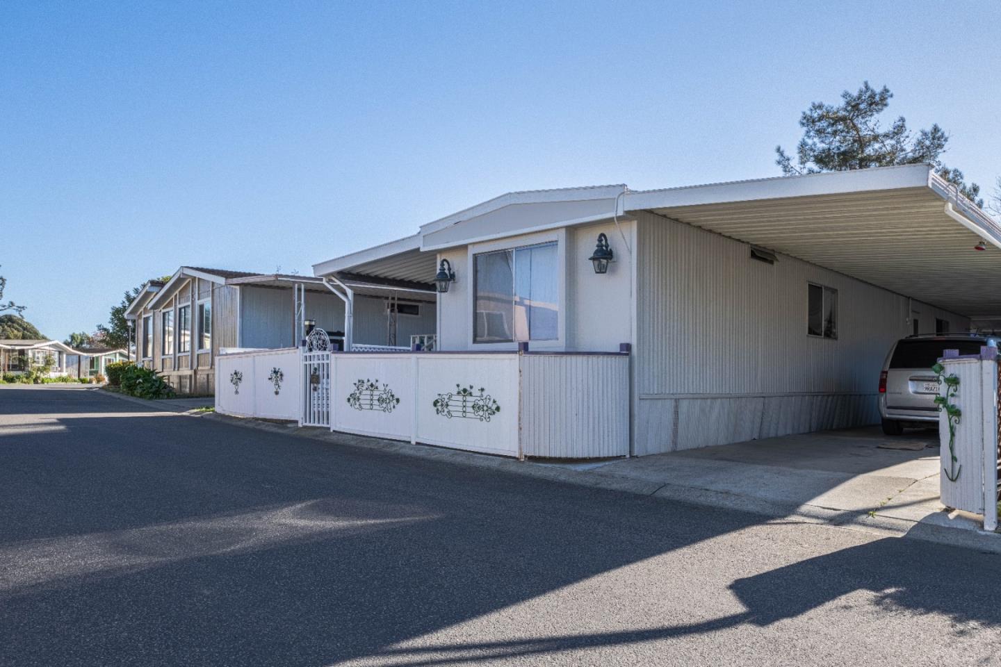 a view of a white house with a street