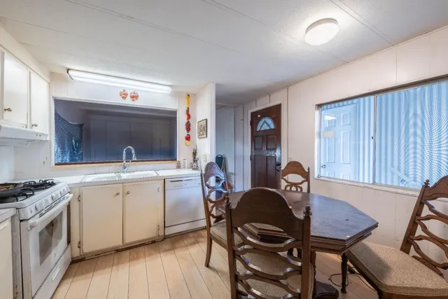 a view of a livingroom with wooden floor and a window
