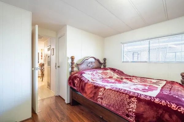 a bedroom with a bed and a desk