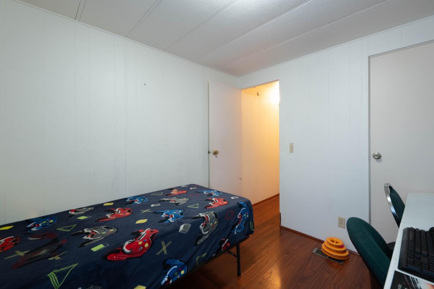 13624 Monte Del Sol, Unit 142 Castroville, CA 95012 - Photo 18 of 25 a bedroom with a bed and a wooden floor