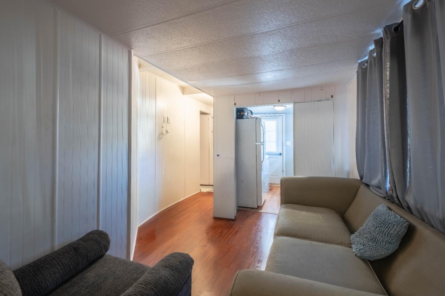 13624 Monte Del Sol, Unit 142 Castroville, CA 95012 - Photo 20 of 25 a living room with furniture and a glass door