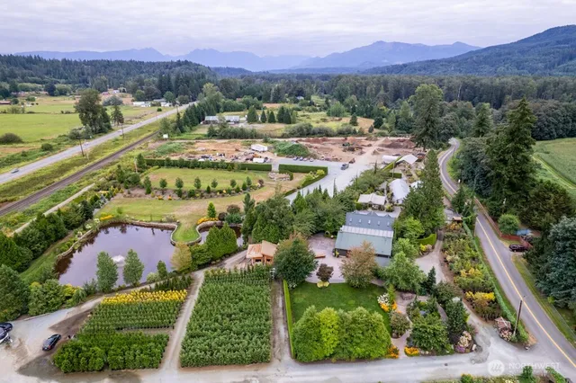 an aerial view of residential houses with outdoor space and river