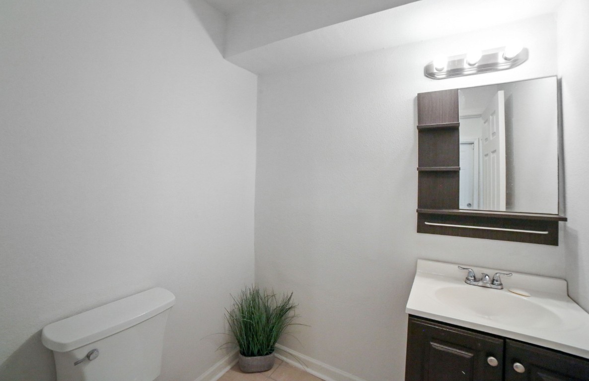 12323 Split Rail Lane Houston, TX 77071 - Photo 11 of 29 a bathroom with a sink a toilet and mirror