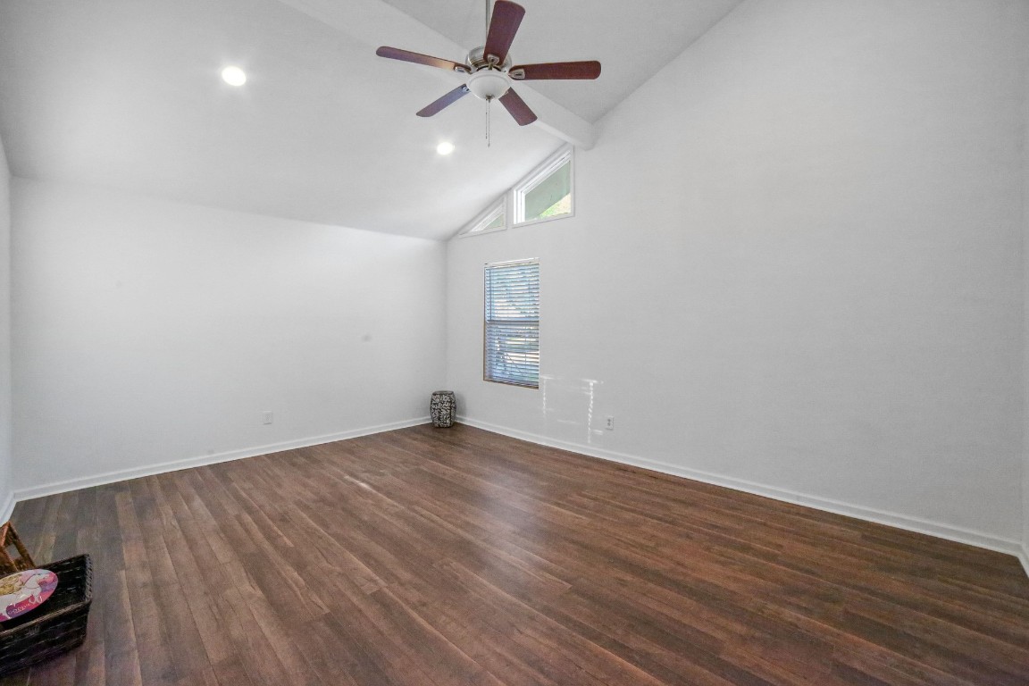 12323 Split Rail Lane Houston, TX 77071 - Photo 4 of 29 an empty room with wooden floor ceiling fan and windows