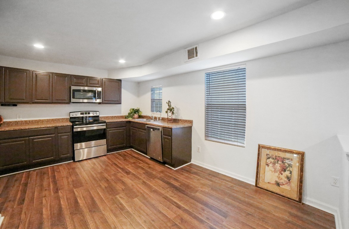 12323 Split Rail Lane Houston, TX 77071 - Photo 7 of 29 a kitchen with granite countertop stainless steel appliances and wooden cabinets