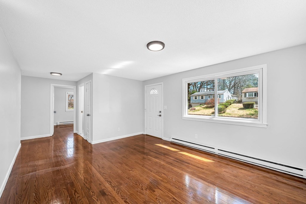 381 North Brook Road Springfield, MA 01119 - Photo 11 of 35 a view of an empty room with wooden floor and a window