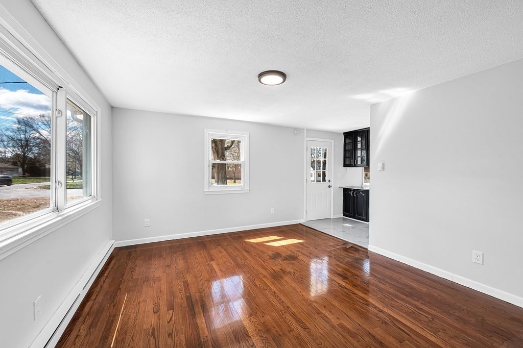 381 North Brook Road Springfield, MA 01119 - Photo 12 of 35 a view of an empty room with window and wooden floor