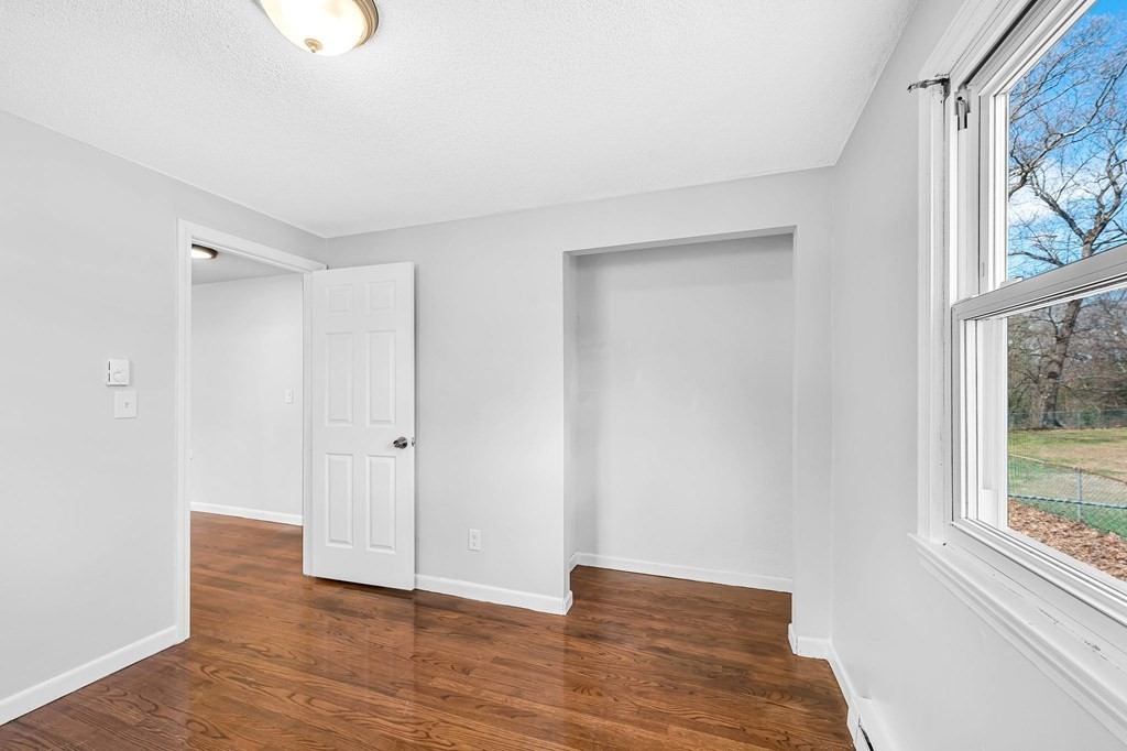 381 North Brook Road Springfield, MA 01119 - Photo 16 of 35 a view of an empty room with wooden floor and a window