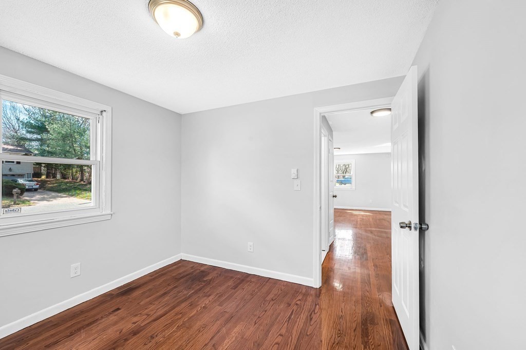 381 North Brook Road Springfield, MA 01119 - Photo 17 of 35 an empty room with wooden floor and windows