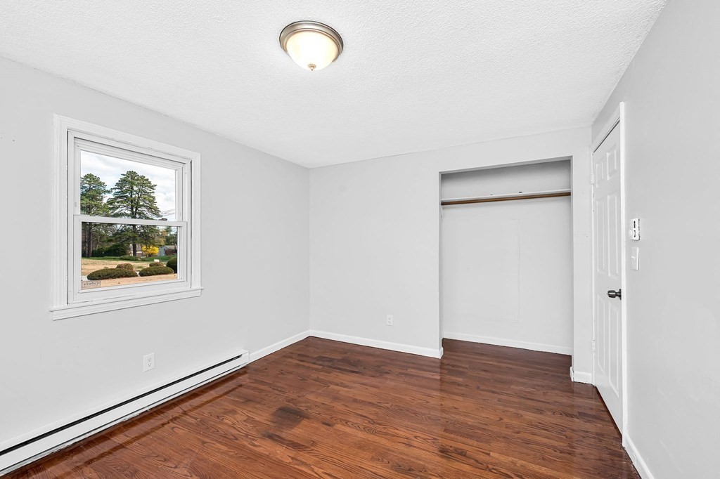 381 North Brook Road Springfield, MA 01119 - Photo 21 of 35 a view of an empty room with wooden floor and a window