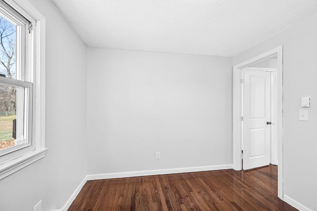 381 North Brook Road Springfield, MA 01119 - Photo 23 of 35 a view of an empty room with wooden floor and a window