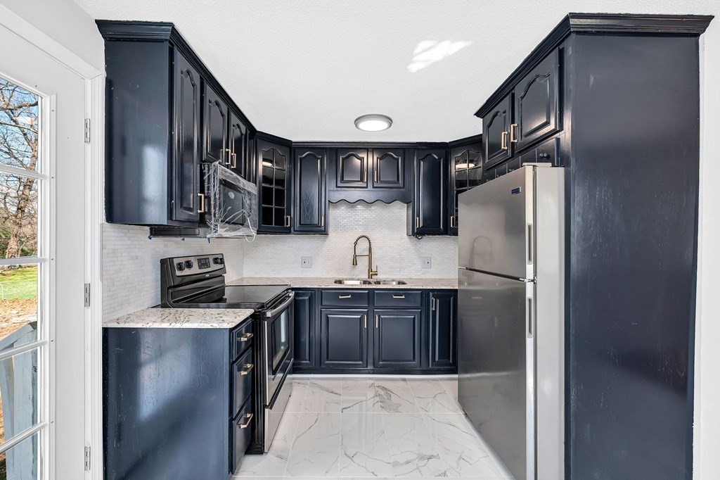 381 North Brook Road Springfield, MA 01119 - Photo 3 of 35 a kitchen with stainless steel appliances granite countertop a refrigerator and a sink