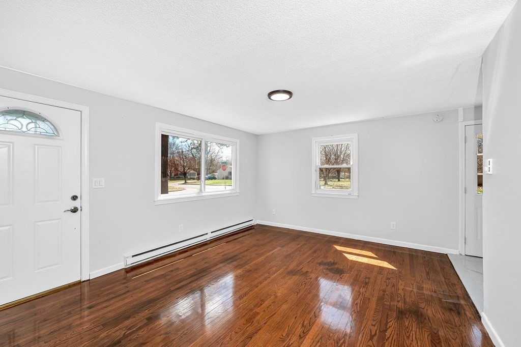 381 North Brook Road Springfield, MA 01119 - Photo 9 of 35 a view of an empty room with wooden floor and a window