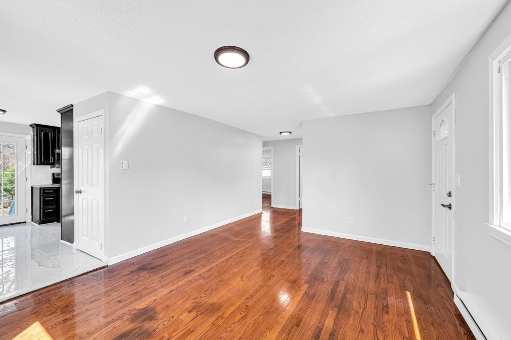 381 North Brook Road Springfield, MA 01119 - Photo 10 of 35 a view of a room with wooden floor and a hallway