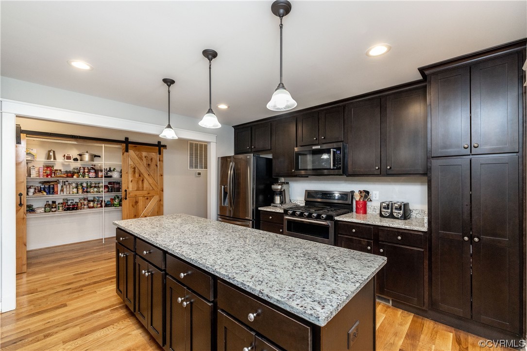 5497 Old Columbia Road Goochland, VA 23063 - Photo 14 of 41 a kitchen with stainless steel appliances granite countertop granite counter tops refrigerator and a wooden floor