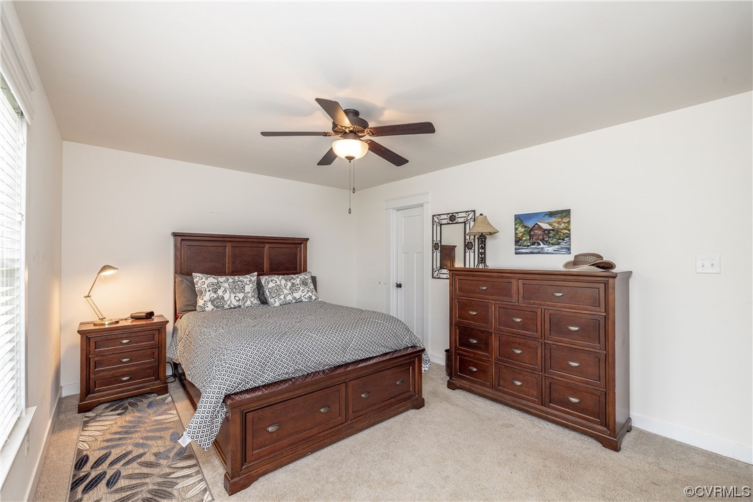 5497 Old Columbia Road Goochland, VA 23063 - Photo 21 of 41 a bedroom with a bed and a chandelier