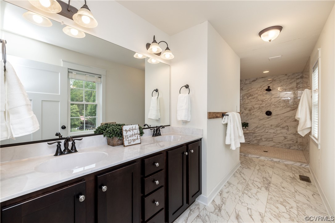 5497 Old Columbia Road Goochland, VA 23063 - Photo 22 of 41 a bathroom with a double vanity sink a mirror a shower and a bathtub