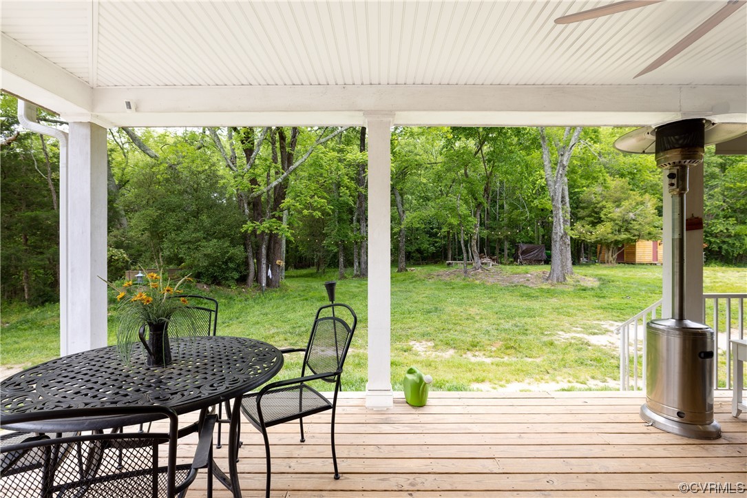 5497 Old Columbia Road Goochland, VA 23063 - Photo 29 of 41 a view of a patio with table and chairs potted plants with wooden floor
