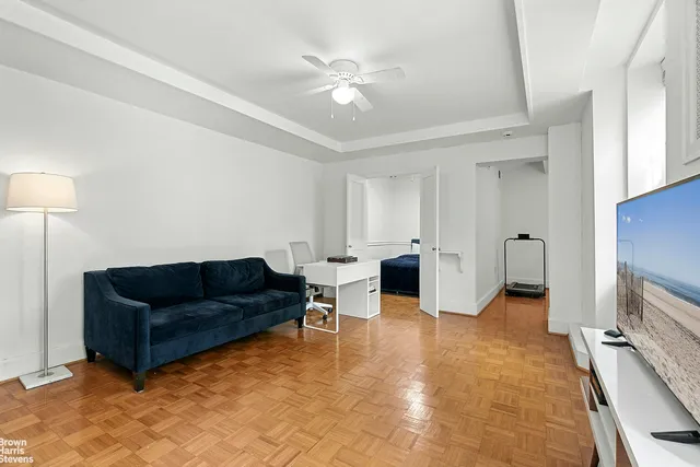 a kitchen with stainless steel appliances a stove a sink a microwave a dining table and chairs