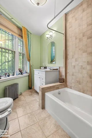 a bathroom with a granite countertop sink a mirror and shower