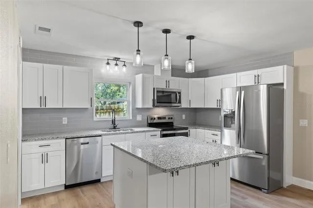 a kitchen with a stove and a microwave