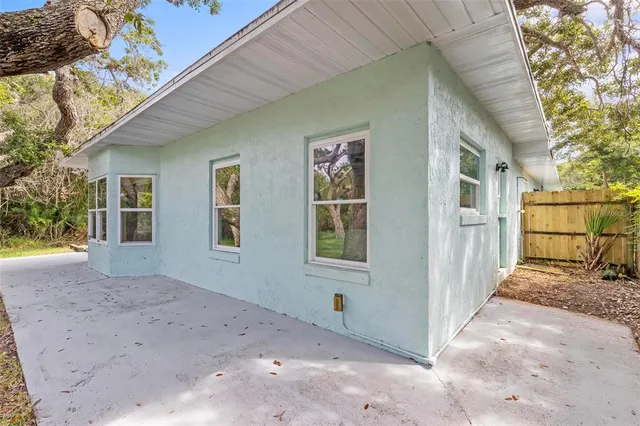 a backyard of a house with large trees