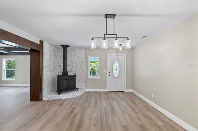 a view of empty room with wooden floor and window