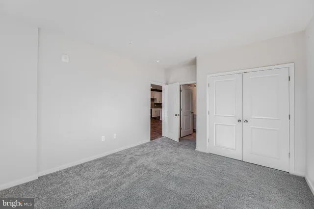 a view of an empty room and closet area