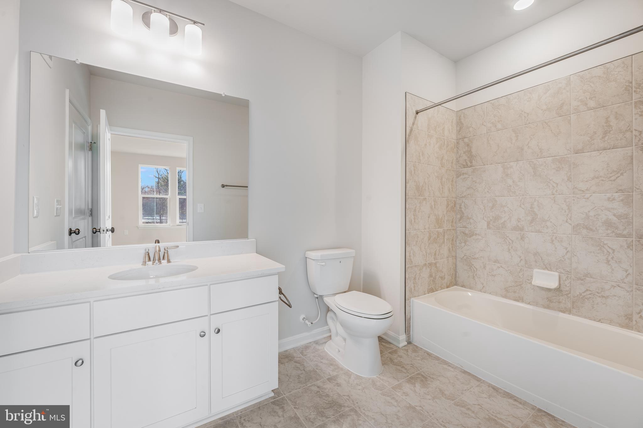 4003 Seaside Alder Road, Unit 409 LILAC Bowie, MD 20720 - Photo 19 of 24 a bathroom with a sink toilet and bathtub
