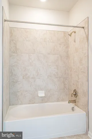 a bathroom with a shower and a bath tub