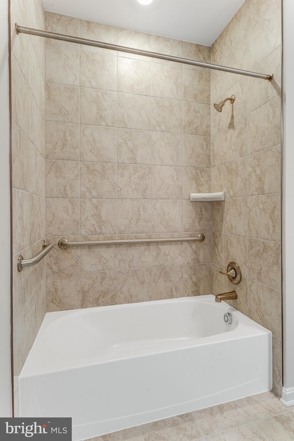 4003 Seaside Alder Road, Unit 409 LILAC Bowie, MD 20720 - Photo 23 of 24 a bathroom with a shower and a bath tub