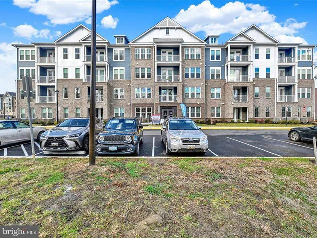 a front view of a house with swimming pool and chairs