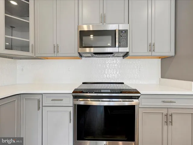 a kitchen with stainless steel appliances a stove a microwave and cabinets
