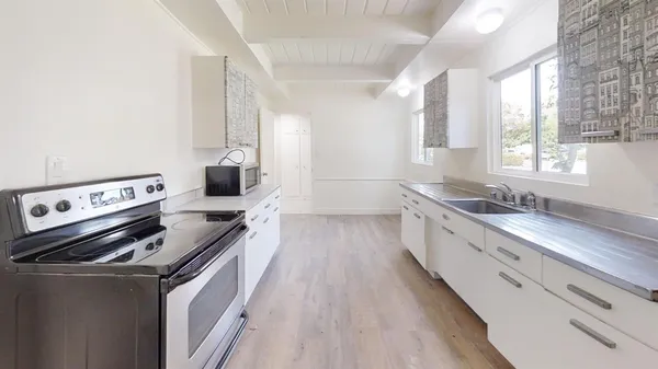 a kitchen with stainless steel appliances granite countertop a stove and a refrigerator