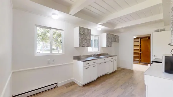 a kitchen with granite countertop a stove and a sink