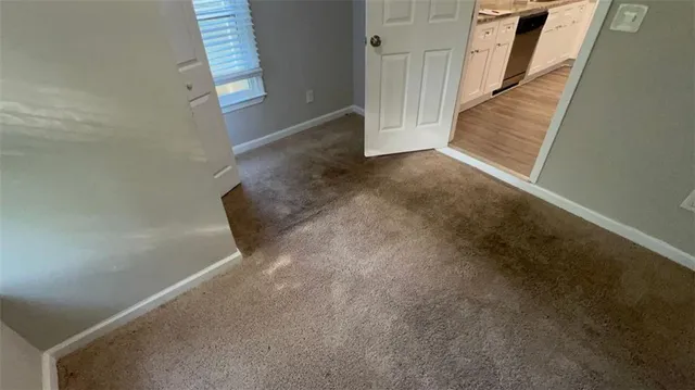 a view of an empty room with stairs