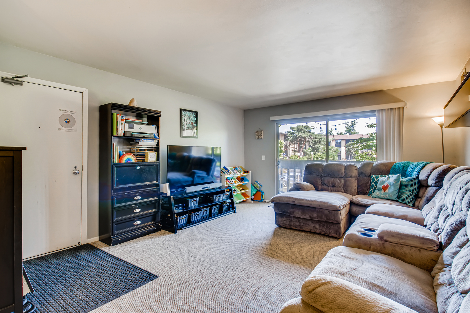 6177 Knoll Wood Road, Unit 201 Willowbrook, IL 60527 - Photo 3 of 11 a living room with furniture and a flat screen tv