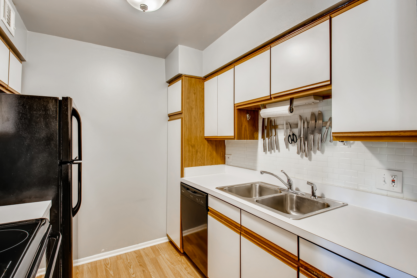 6177 Knoll Wood Road, Unit 201 Willowbrook, IL 60527 - Photo 5 of 11 a kitchen with a sink and refrigerator