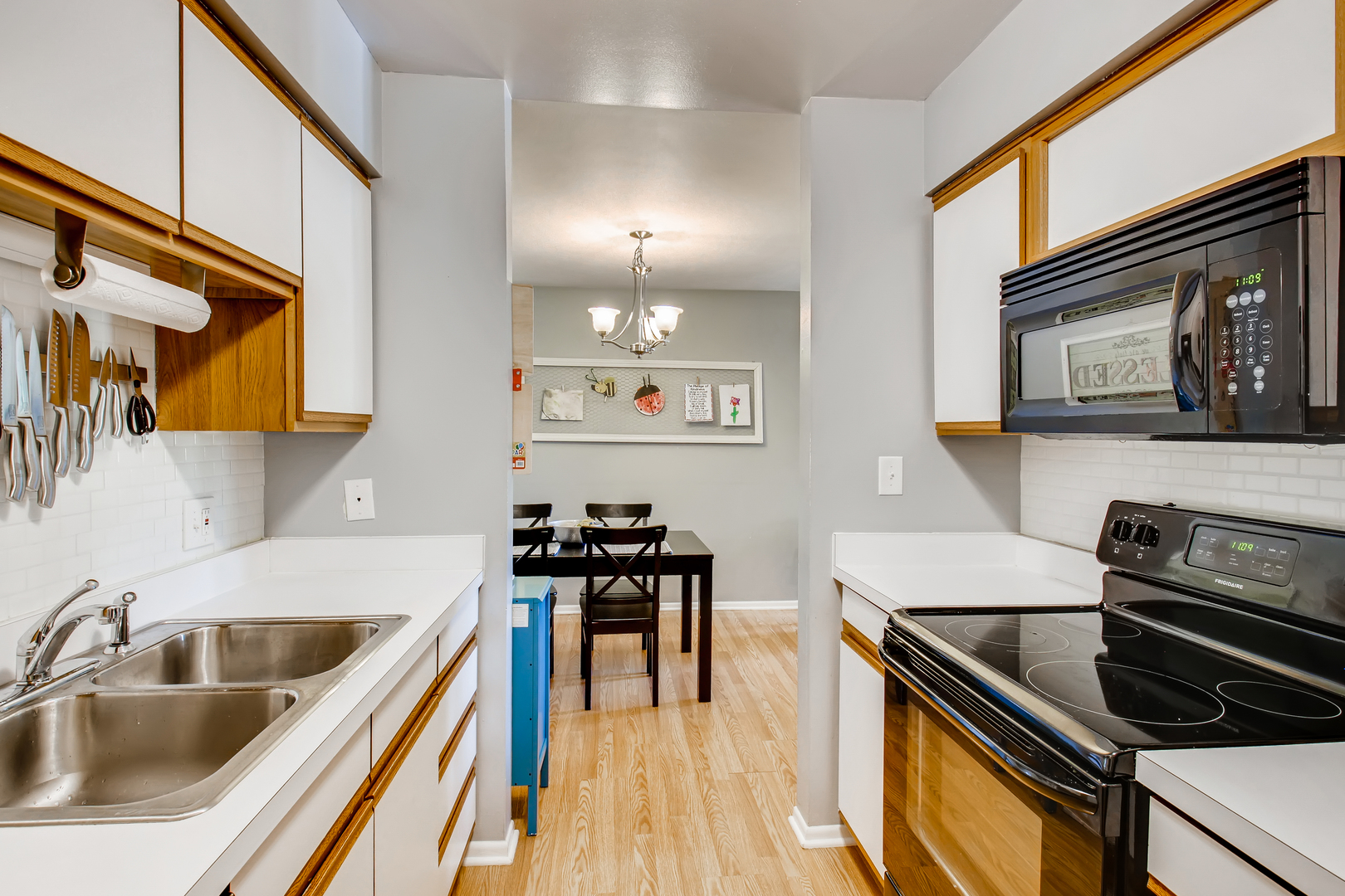 6177 Knoll Wood Road, Unit 201 Willowbrook, IL 60527 - Photo 6 of 11 a kitchen that has a sink and a stove