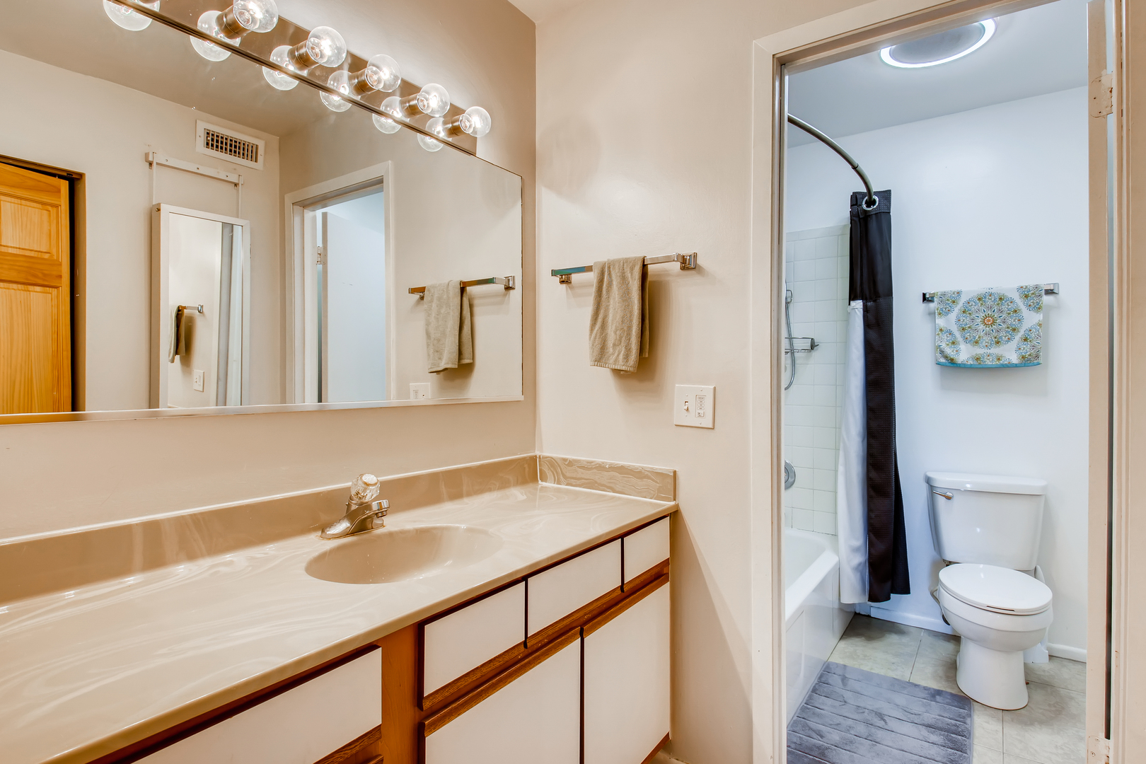 6177 Knoll Wood Road, Unit 201 Willowbrook, IL 60527 - Photo 8 of 11 a bathroom with a sink toilet a mirror and shower