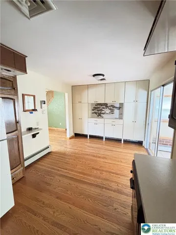 a kitchen with stainless steel appliances a refrigerator and wooden cabinets