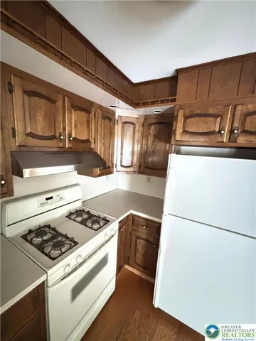 a kitchen with a stove and a refrigerator
