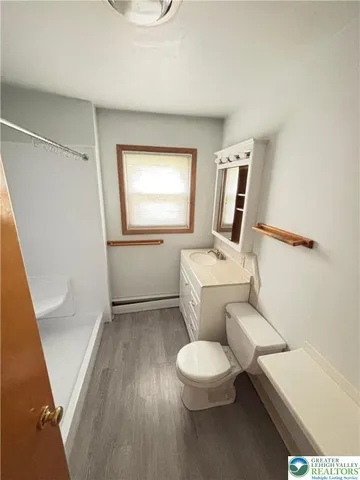 a white toilet sitting next to a bathroom sink
