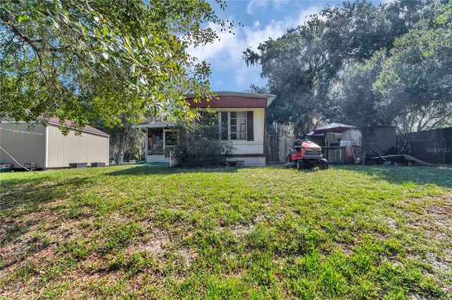 a front view of a house with a garden and yard