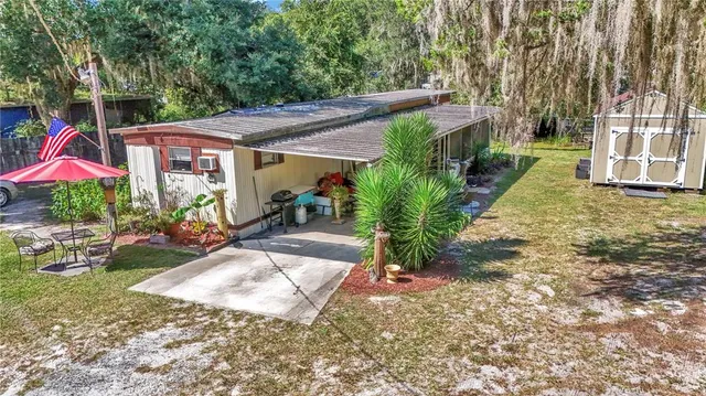 a view of yard with patio